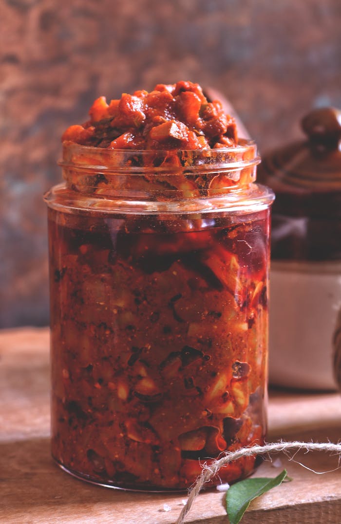 Close-up of a jar filled with spicy homemade pickles, showcasing vibrant colors and textures.